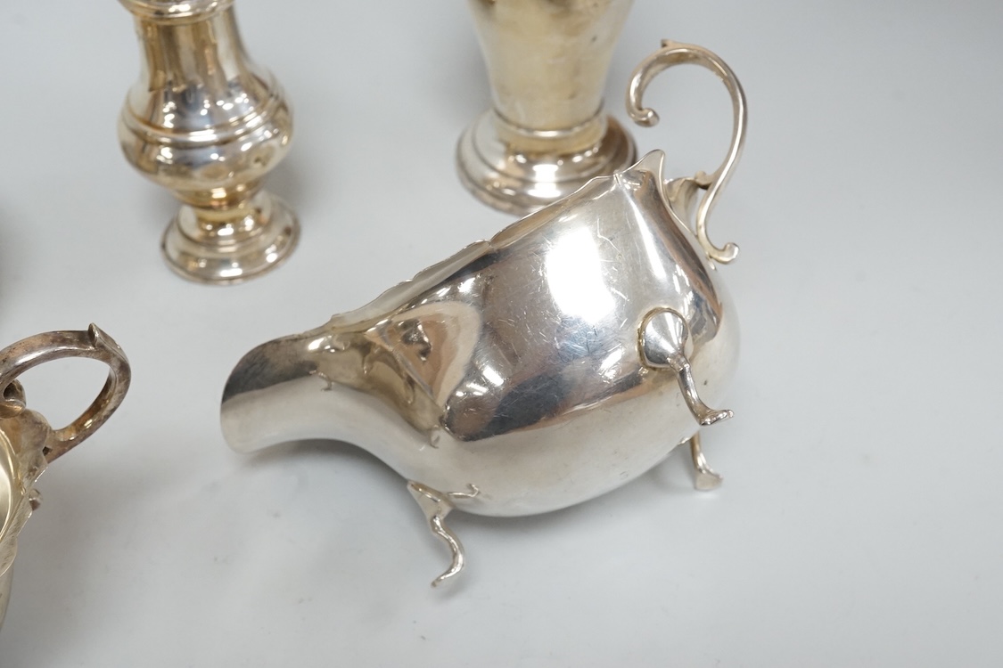 Two George V silver sauceboats, one by Asprey & Co, a silver pepperette, a silver bowl and a modern silver sugar caster, 16oz.